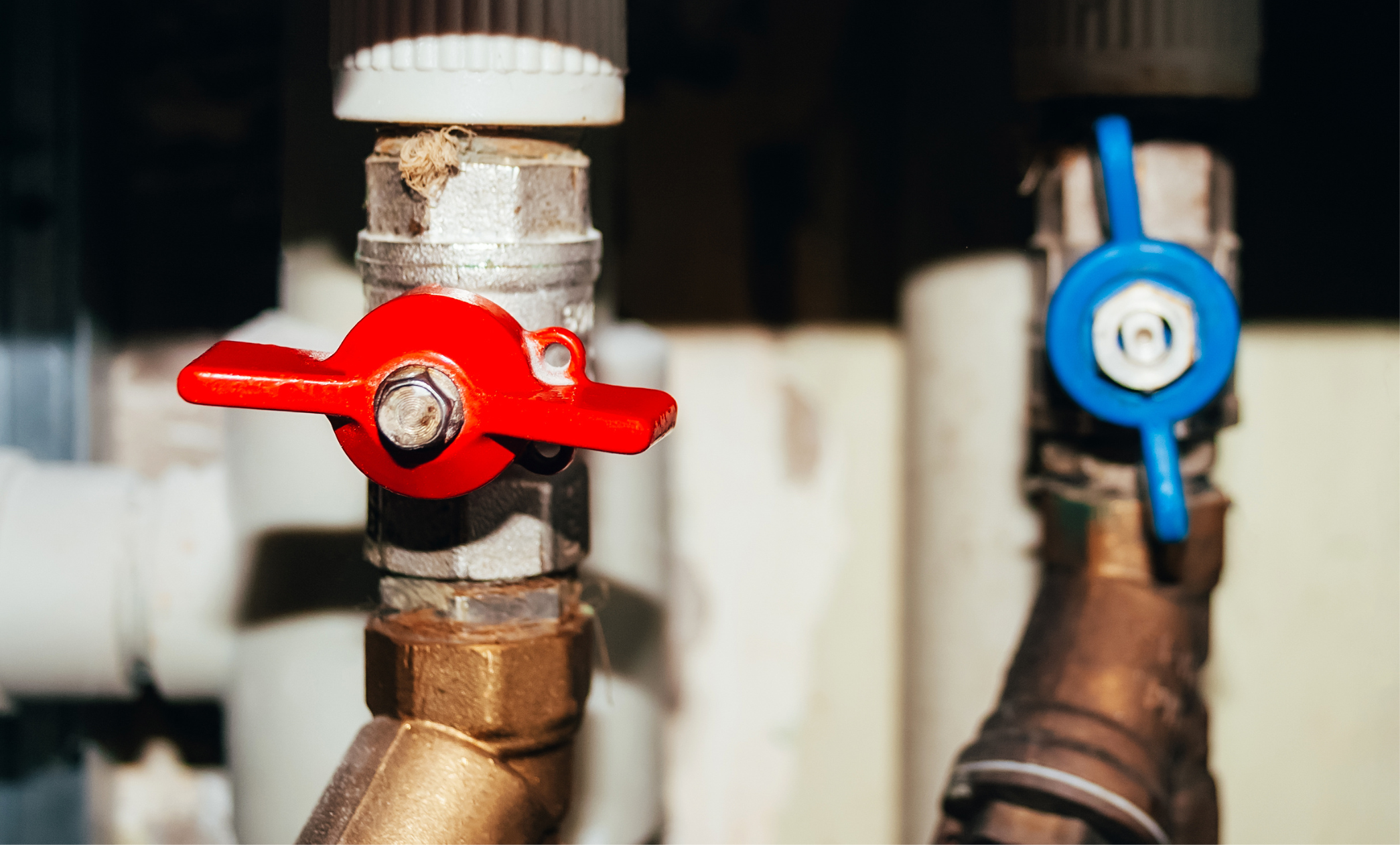 Two valves on pipes with hot and cold water